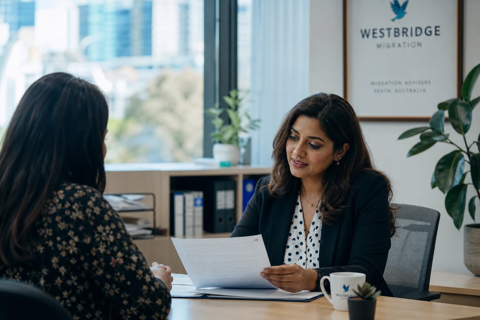 Parveen Kumar reviewing visa documents with a client during an office consultation